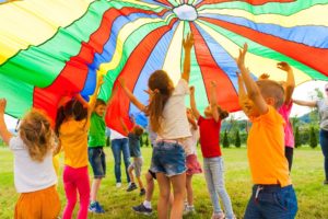 Group of Children Playing with a Parachute