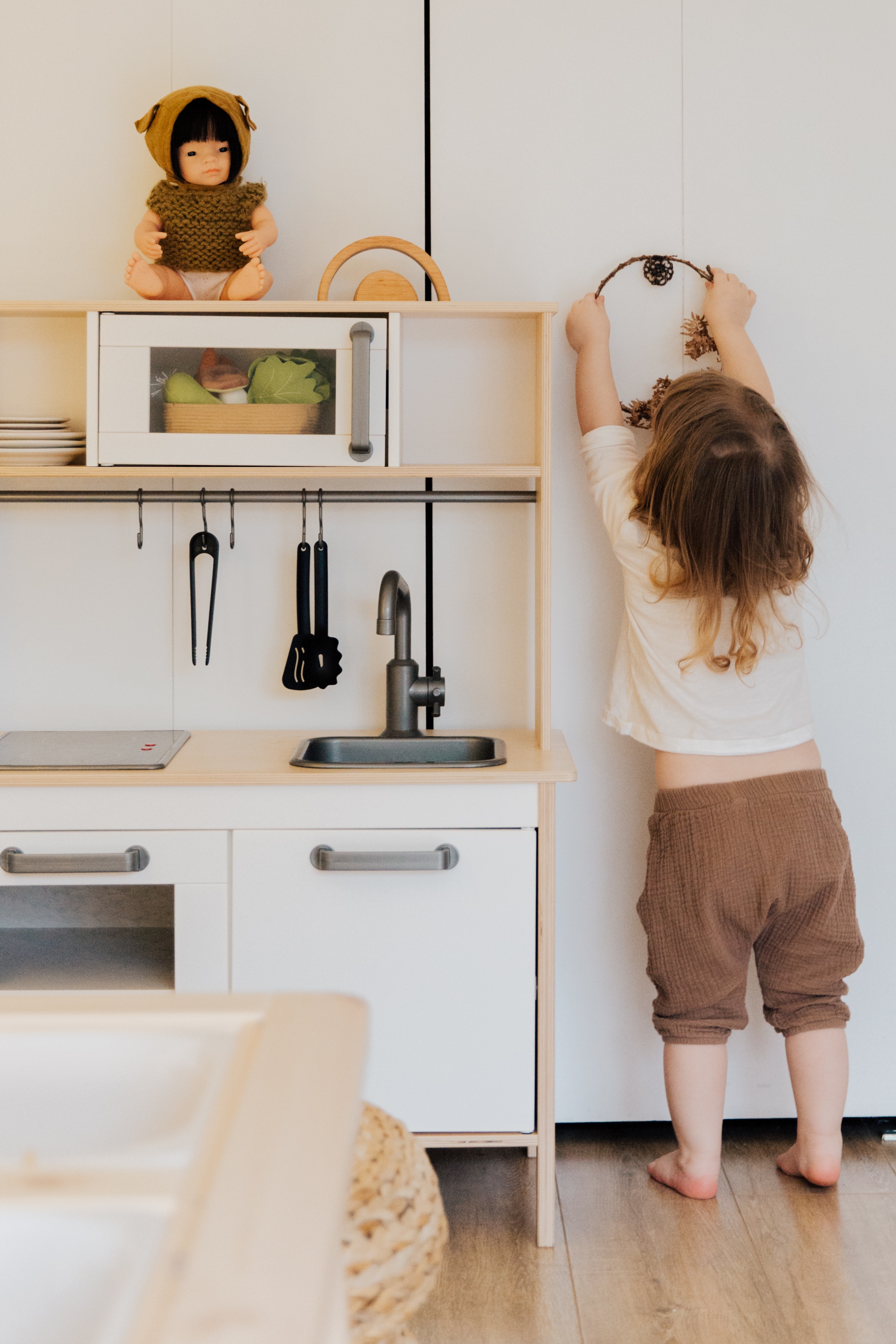 Young Girl Playing in Kitchen Playset