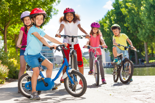 kids using smart safety habits while riding bikes during the summer